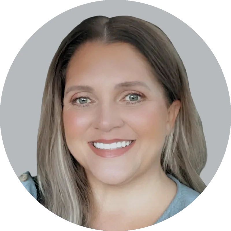Portrait of Nurse Practitioner Erica Stanley wearing a light blue shirt, smiling with a light gray background