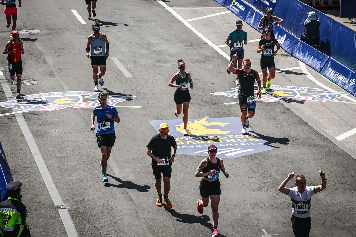 Runners, Dr. Timothy Deer among them, on the 2025 Boston Marathon course near mile 25