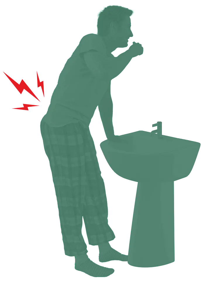 Person supporting himself at a sink due to low back pain