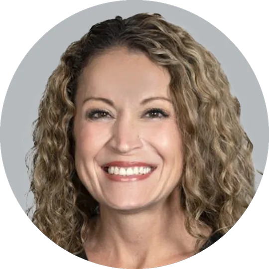 Portrait of Nurse Practitioner Rebecca Butcher, smiling with a light gray background.