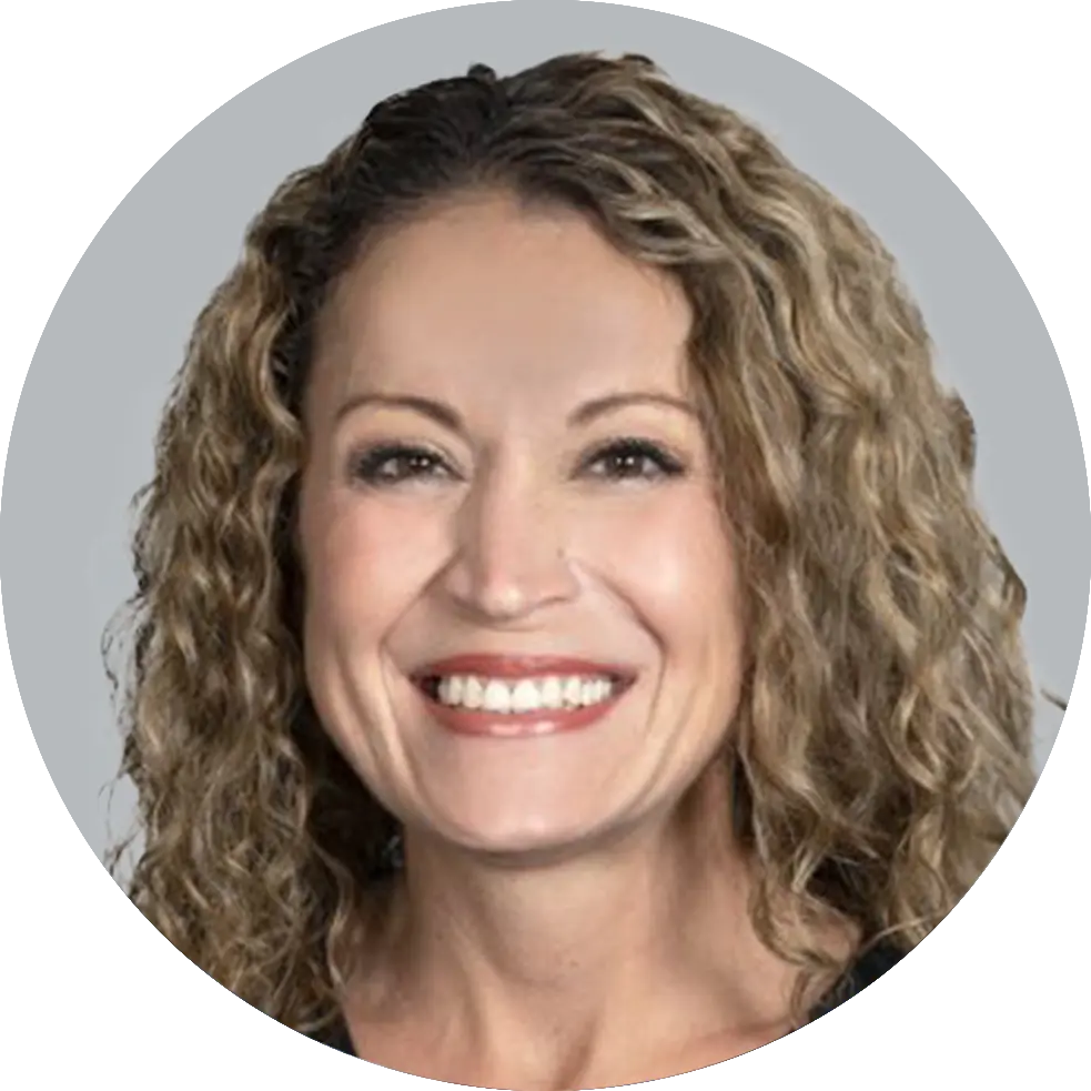 Portrait of Nurse Practitioner Rebecca Butcher, smiling with a light gray background.”