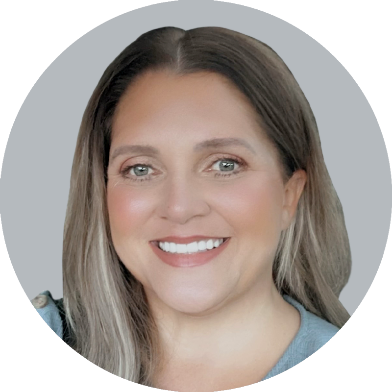 Portrait of Nurse Practitioner Erica Stanley wearing a light blue shirt, smiling with a light gray background